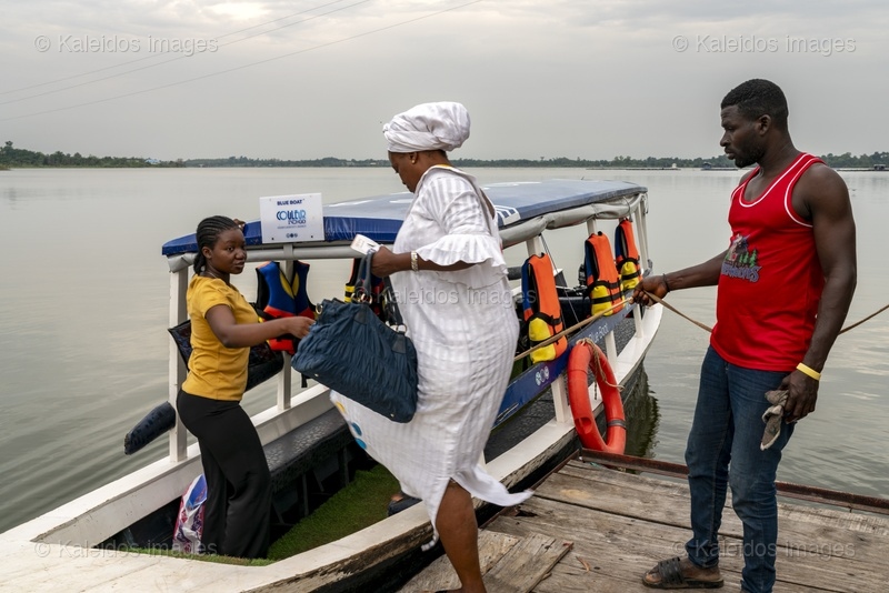 Lake Toho;Ouidah;Benin;West Africa;Indigo Village;Blue Boat;Couleur Indigo;eco-tourism;tourist boat;boarding;life jacket;boubou;traditional clothing;lake tourism;West Africa tourism;Tarek Charara;Kaleidos;Kaleidos images;La parole à l'image