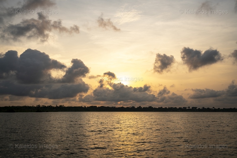 Lake Toho;Ouidah;Benin;West Africa;sunset;golden hour;clouds;dramatic sky;cumulus;orange light;lake landscape;nature;reflection;no people;travel;Tarek Charara;Kaleidos;Kaleidos images;La parole à l'image