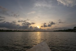 Lake-Toho;Ouidah;Benin;West-Africa;sunset;golden-hour;pirogue;bow;orange-sky;clouds;light-reflection;lake-crossing;point-of-view;travel;West-Africa-landscape;Tarek-Charara;Kaleidos;Kaleidos-images;La-parole-à-limage