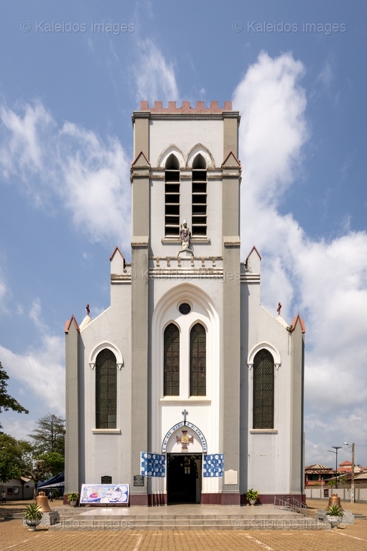 Benin, Ouidah, basilica, Basilica of the Immaculate Conception, Neo-Gothic architecture, Catholic church, façade, bell tower, Latin cross, religious heritage, West Africa, missionaries, SMA, Society of African Missions, Louis Dartois, François Steinmetz, minor basilica, 1903, 1909, John Paul II, exterior, colonial architecture, Dahomey;places of worship,Churches

