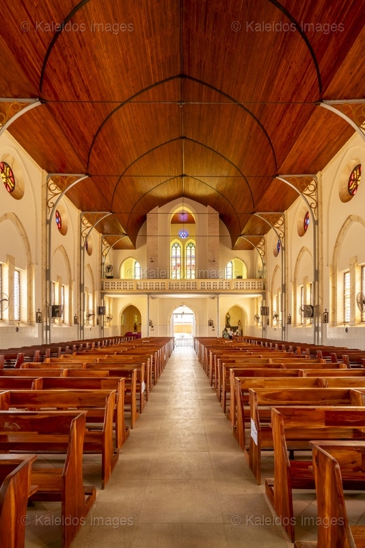 Benin, Ouidah, Basilica of the Immaculate Conception, interior, nave, perspective, portal, vault, colonnades, pews, stained glass, Neo-Gothic architecture, chancel, religious heritage, West Africa, minor basilica, 1909, Tarek Charara;Kaleidos;Kaleidos images;La parole à l'image;Places of worship
