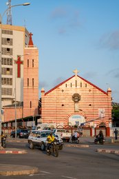 Architecture;-Avenue-Clozel;-Benin;-Cathedral;-Cotonou;-Facade;-Kaleidos;-Kaleidos-images;-La-parole-à-limage;-Motorbike-taxi;-Notre-Dame-de-Miséricorde;-Places-of-worship;-Red-and-white-stripes;-Stories-Pictures;-Tarek-Charara