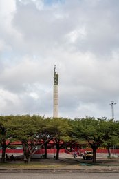 Benin;-Cotonou;-Kaleidos;-Kaleidos-images;-La-parole-à-limage;-Marxism-Leninism;-Monument;-Pergola;-Place-de-lÉtoile-Rouge;-Quiet-urban-scene;-Red-star;-Revolutionary-architecture;-Roundabout;-Statue;-Stories-Pictures;-Tarek-Charara;-Trees;-West-Africa