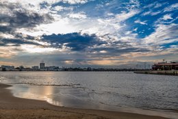 Beach;-Benin;-Buildings;-Channel;-City;-Clouds;-Coastline;-Corniche-Est;-Cotonou;-Dramatic-sky;-Gulf-of-Benin;-Kaleidos;-Kaleidos-images;-La-parole-à-limage;-Lagoon;-Late-afternoon;-Quay;-Reflections;-Skyline;-Stories-Pictures;-Tarek-Charara;-West-Africa