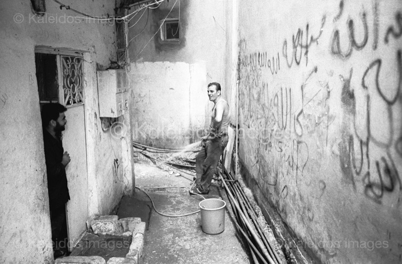 Alleys;Clean;Cleaning;Kaleidos images;Man;Men;Palestinian Refugees;Palestinians;Penumbra;Refugee camps;Shatila;Tarek Charara;UNRWA